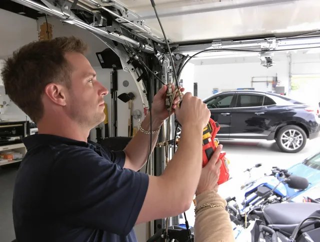 Poinciana Garage Door Repair safety certified technician performing cable replacement in Poinciana
