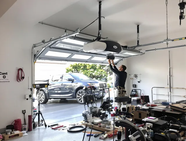 Poinciana Garage Door Repair specialist installing smart garage door opener system in Poinciana home